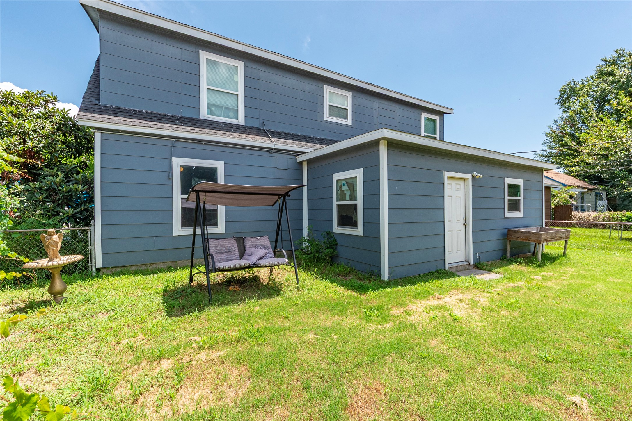2801 Virginia Street, Unit B Baytown, TX 77520 - Photo 19 of 20 a view of a house with a yard and sitting area