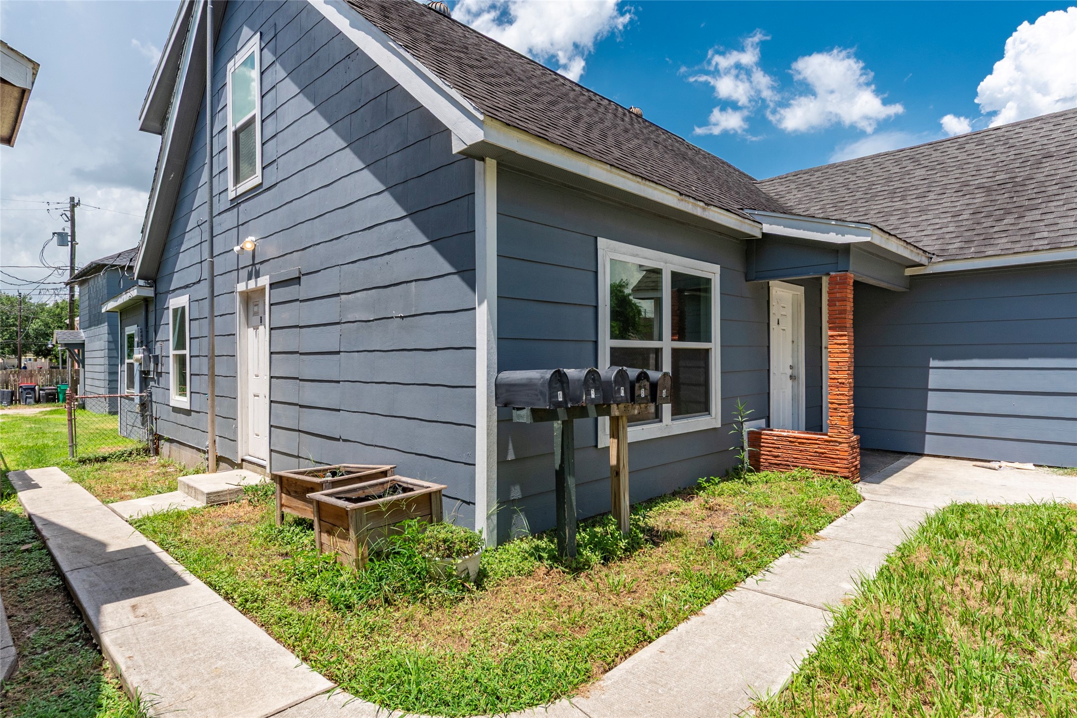 2801 Virginia Street, Unit B Baytown, TX 77520 - Photo 2 of 20 a front view of a house with garden