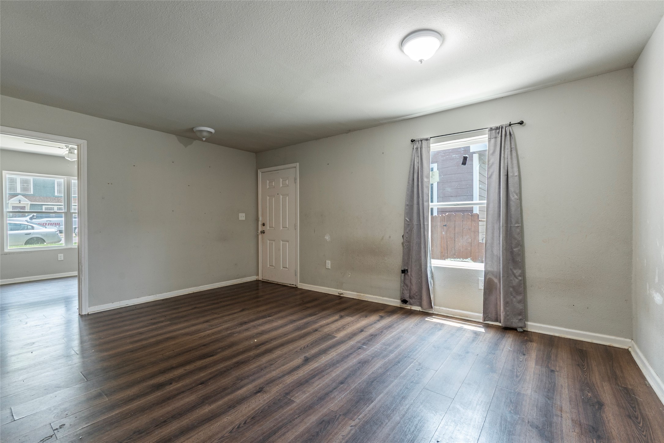 2801 Virginia Street, Unit B Baytown, TX 77520 - Photo 4 of 20 an empty room with wooden floor and windows