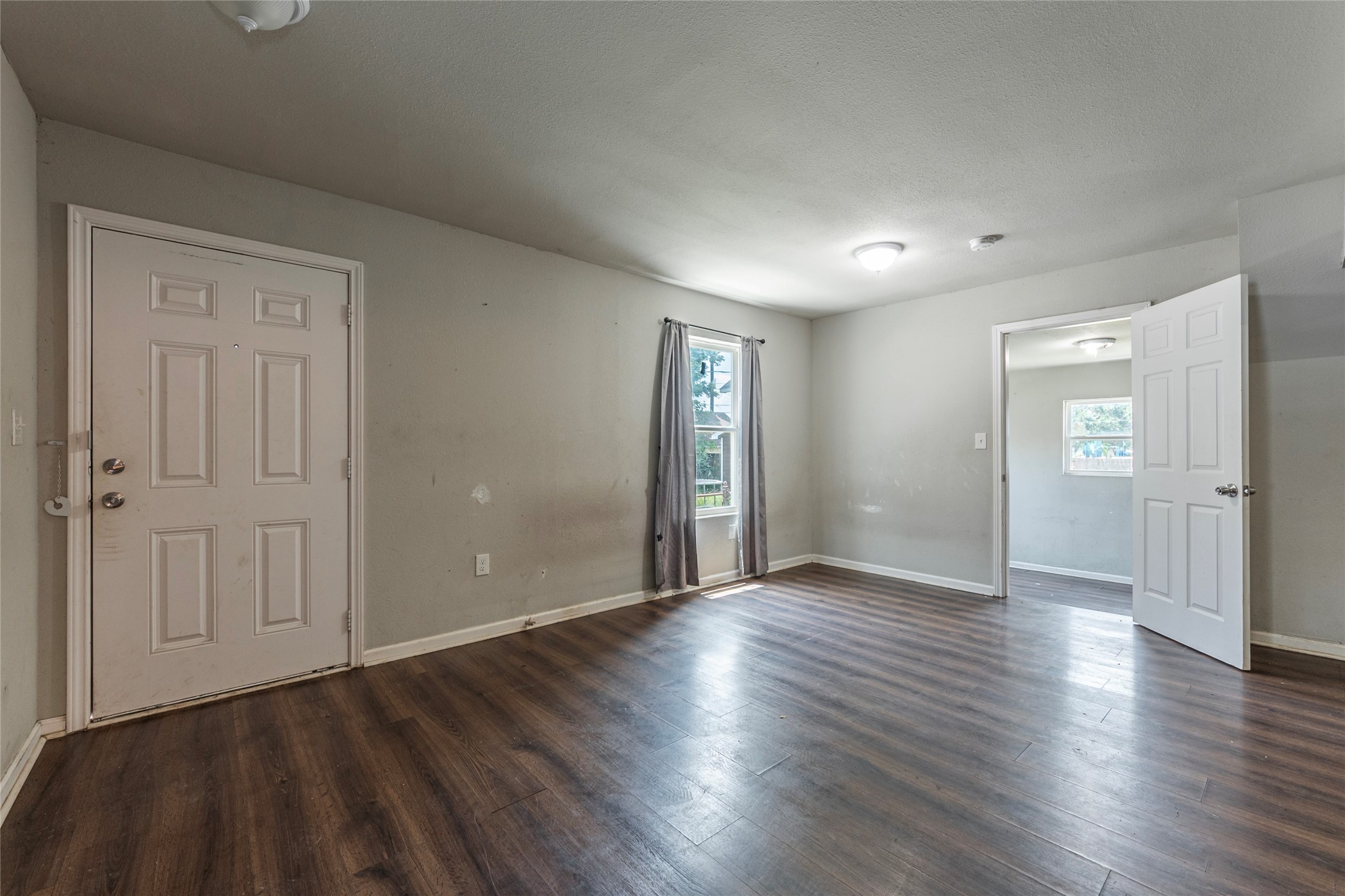 2801 Virginia Street, Unit B Baytown, TX 77520 - Photo 5 of 20 an empty room with wooden floor & windows