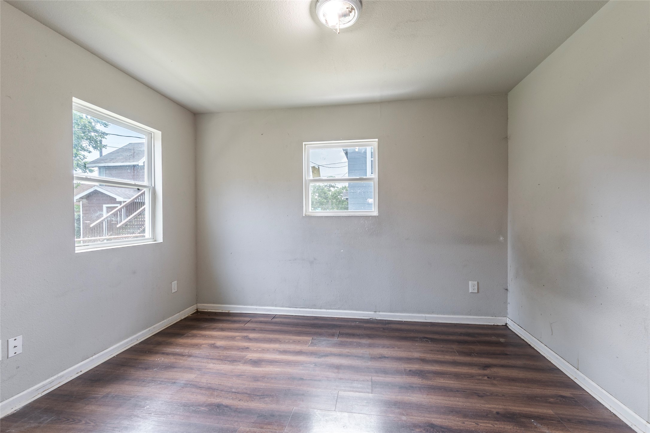 2801 Virginia Street, Unit B Baytown, TX 77520 - Photo 10 of 20 an empty room with wooden floor and windows