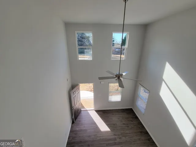 a view of a room with wooden floor