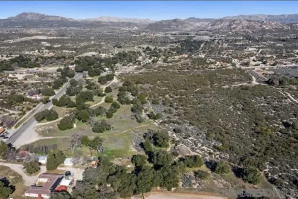 an aerial view of residential house and covered with trees