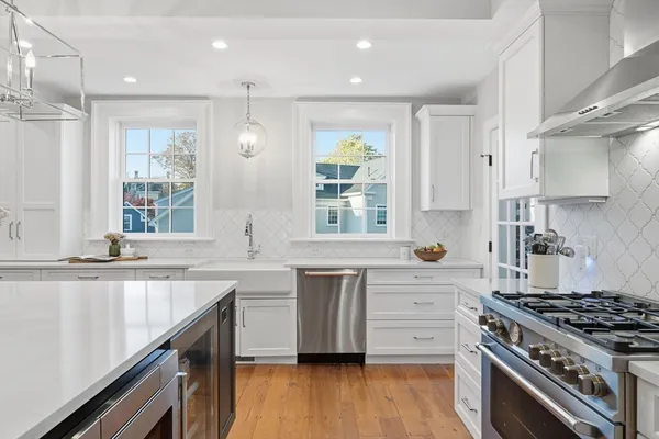 a kitchen with refrigerator cabinets dining table and chairs