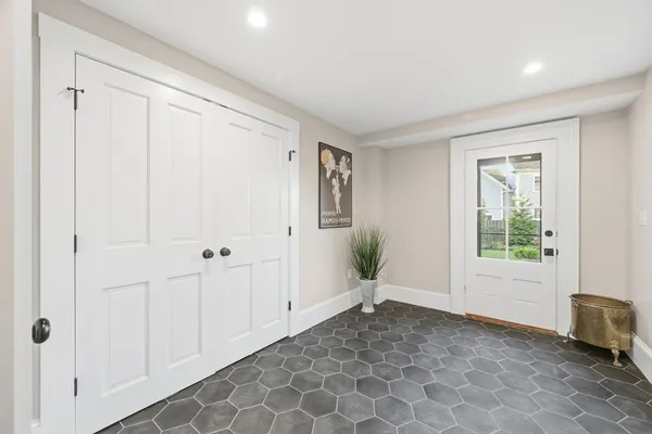 an empty room with windows and closet