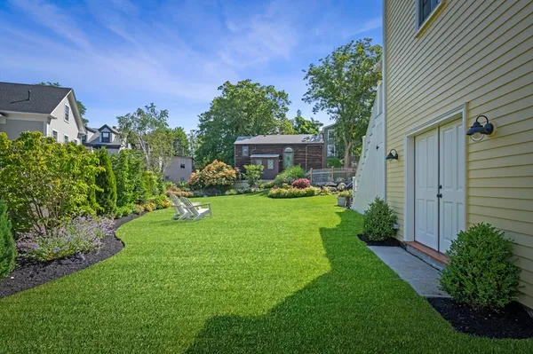 an outdoor space with seating area and trees