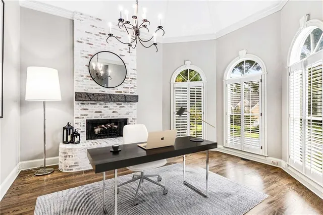 a living room with furniture fireplace and flat screen tv