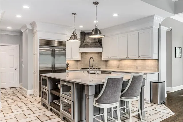 a kitchen with stainless steel appliances a stove and a refrigerator