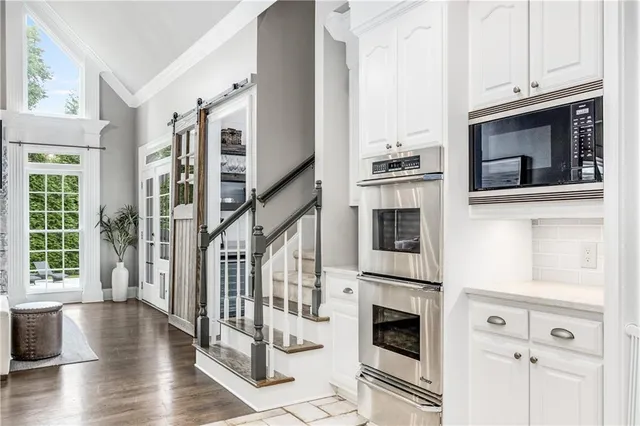 a spacious bedroom with a bed and a flat screen tv