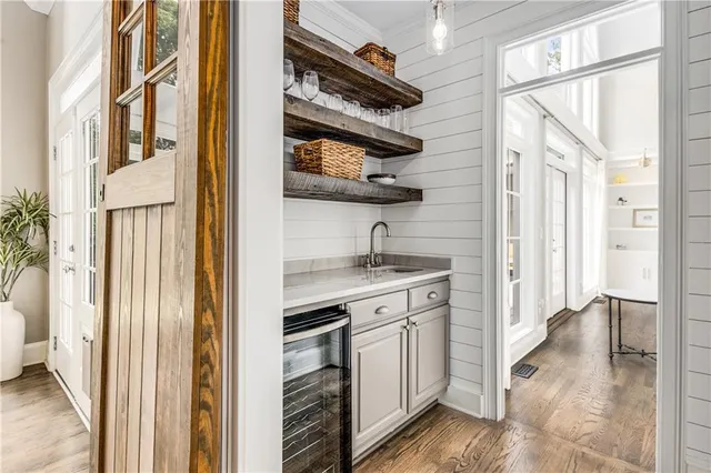 a bathroom with a double vanity sink a toilet a mirror and shower
