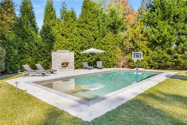 a view of a swimming pool with a yard