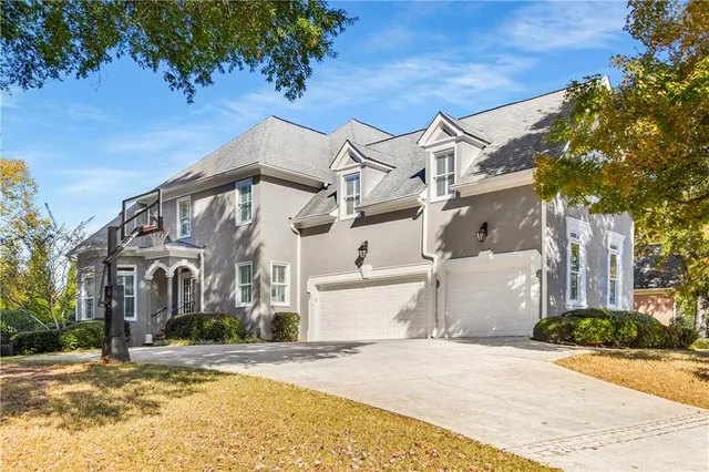 an aerial view of residential houses with outdoor space and trees