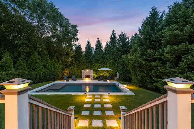 a living room with fireplace furniture and a large window