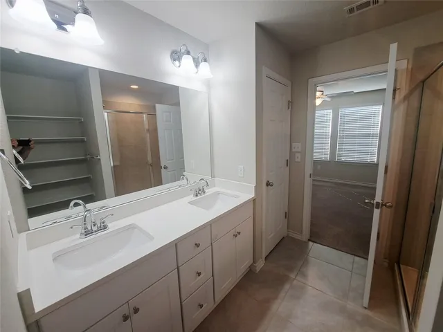 a bathroom with a double vanity sink mirror and double