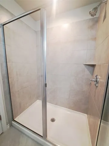 a bathroom with a shower and a bath tub