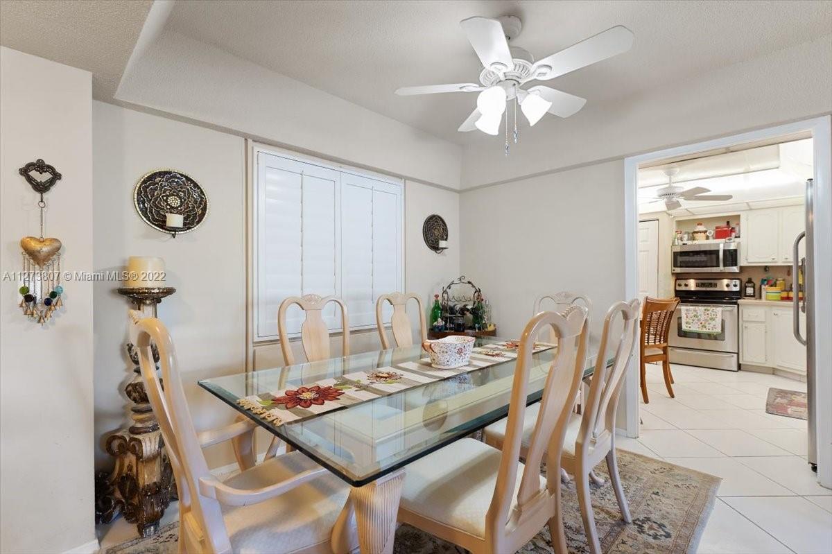 501 Southwest 11th Place, Unit 110 Boca Raton, FL 33432 - Photo 40 of 42 a view of a dining room with furniture