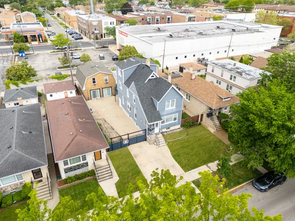 an aerial view of residential houses with outdoor space