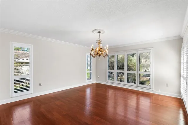 a spacious bedroom with a large bed and a tv