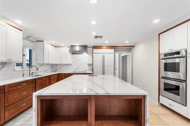 an aerial view of a houses with a lake view