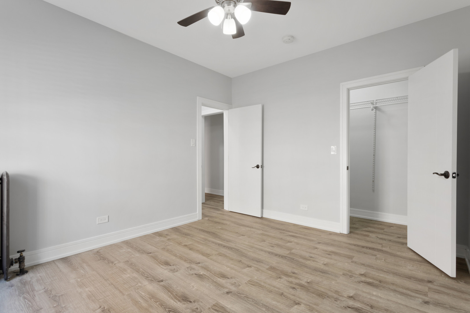6942 North Wolcott Avenue, Unit 1 Chicago, IL 60626 - Photo 11 of 15 a view of an empty room with wooden floor and a ceiling fan