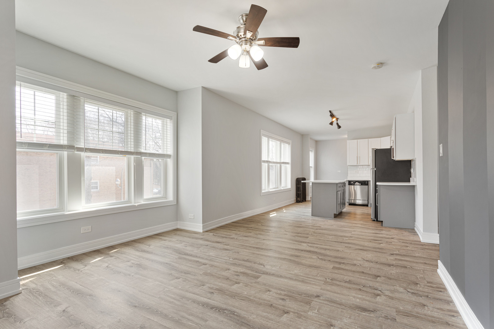 6942 North Wolcott Avenue, Unit 1 Chicago, IL 60626 - Photo 2 of 15 a view of empty room with a window and kitchen view