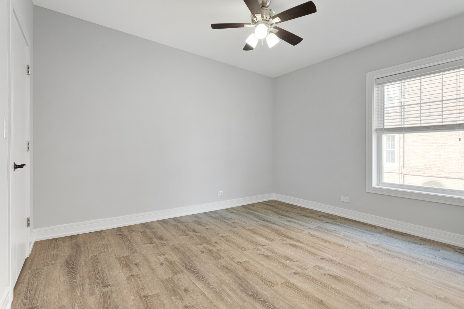6942 North Wolcott Avenue, Unit 1 Chicago, IL 60626 - Photo 9 of 15 wooden floor in an empty room with a window