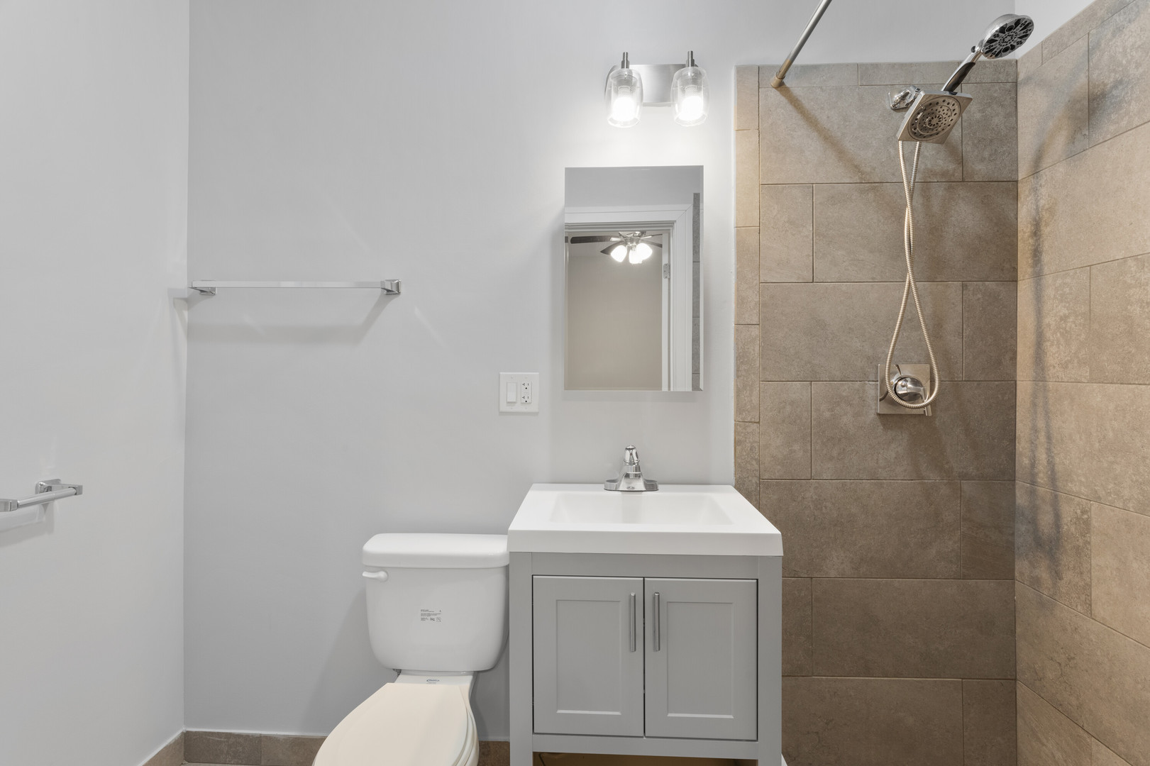 6942 North Wolcott Avenue, Unit 1 Chicago, IL 60626 - Photo 10 of 15 a bathroom with a sink a toilet and shower