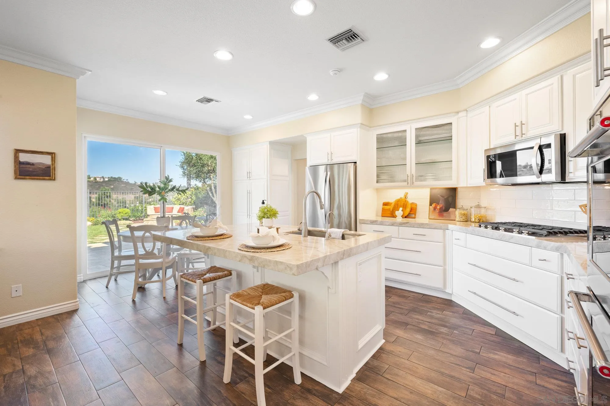 2822 Rancho Pancho Carlsbad, CA 92009 - Photo 1 of 26 a kitchen with stainless steel appliances granite countertop a stove a sink dishwasher a stove and white cabinets with wooden floor