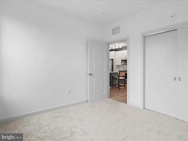 a bedroom with a balcony a bed and a potted plant