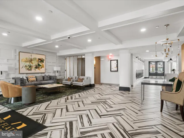 a picture of a living room with furniture and kitchen view