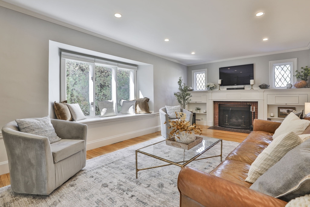 10 Lawndale Road Milton, MA 02186 - Photo 12 of 42 a living room with furniture a flat screen tv and a fireplace