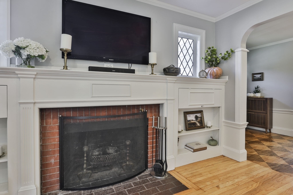 10 Lawndale Road Milton, MA 02186 - Photo 15 of 42 a living room with a fireplace and a flat screen tv