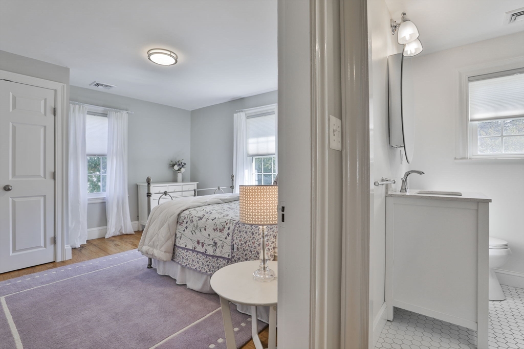 10 Lawndale Road Milton, MA 02186 - Photo 23 of 42 a bedroom with a bed and a chandelier