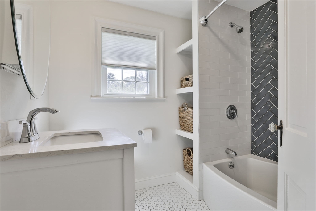 10 Lawndale Road Milton, MA 02186 - Photo 28 of 42 a bathroom with a tub sink and mirror