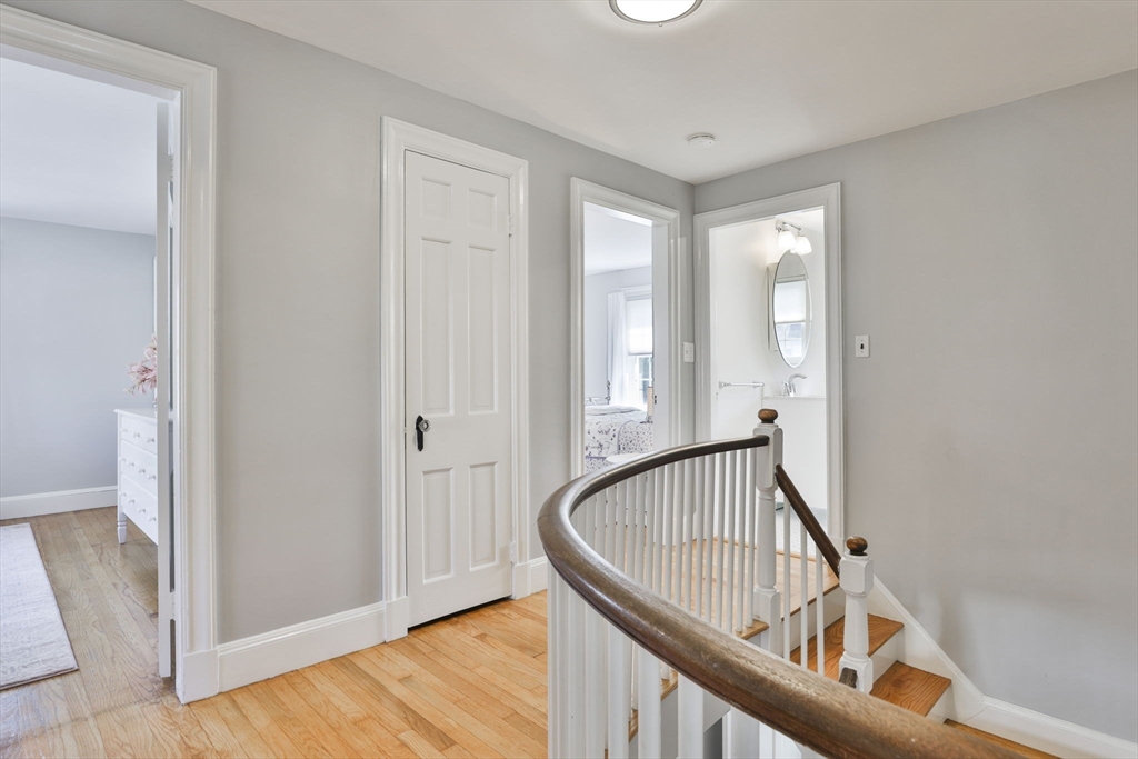 10 Lawndale Road Milton, MA 02186 - Photo 31 of 42 a view of a hallway with wooden floor and staircase