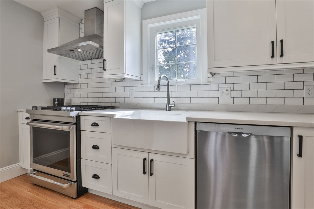 10 Lawndale Road Milton, MA 02186 - Photo 6 of 42 a kitchen with a sink stove and cabinets