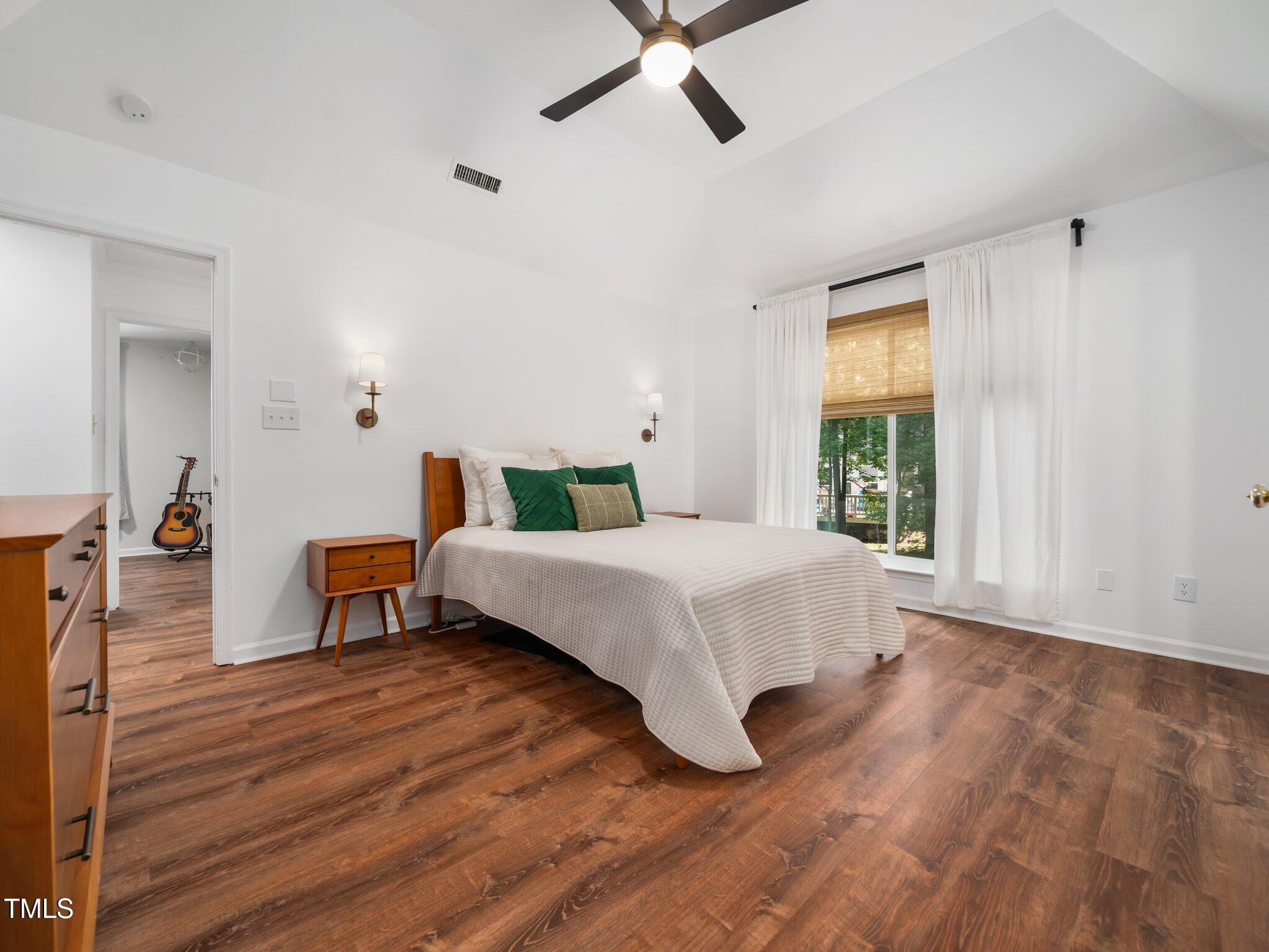 3400 Appling Way Durham, NC 27703 - Photo 12 of 30 a bedroom with a bed and wooden floor