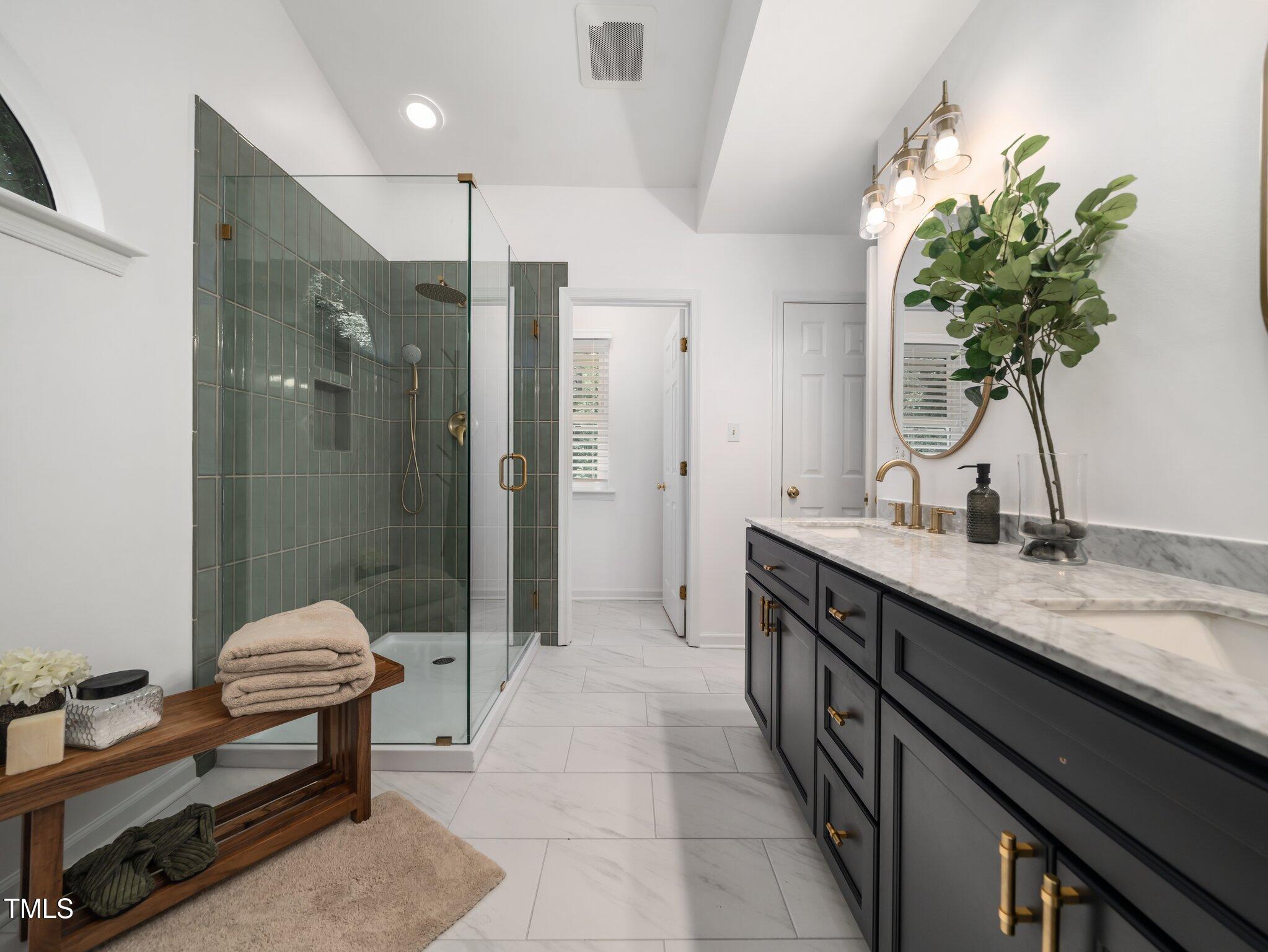 3400 Appling Way Durham, NC 27703 - Photo 16 of 30 a spacious bathroom with a granite countertop sink a toilet a mirror and shower