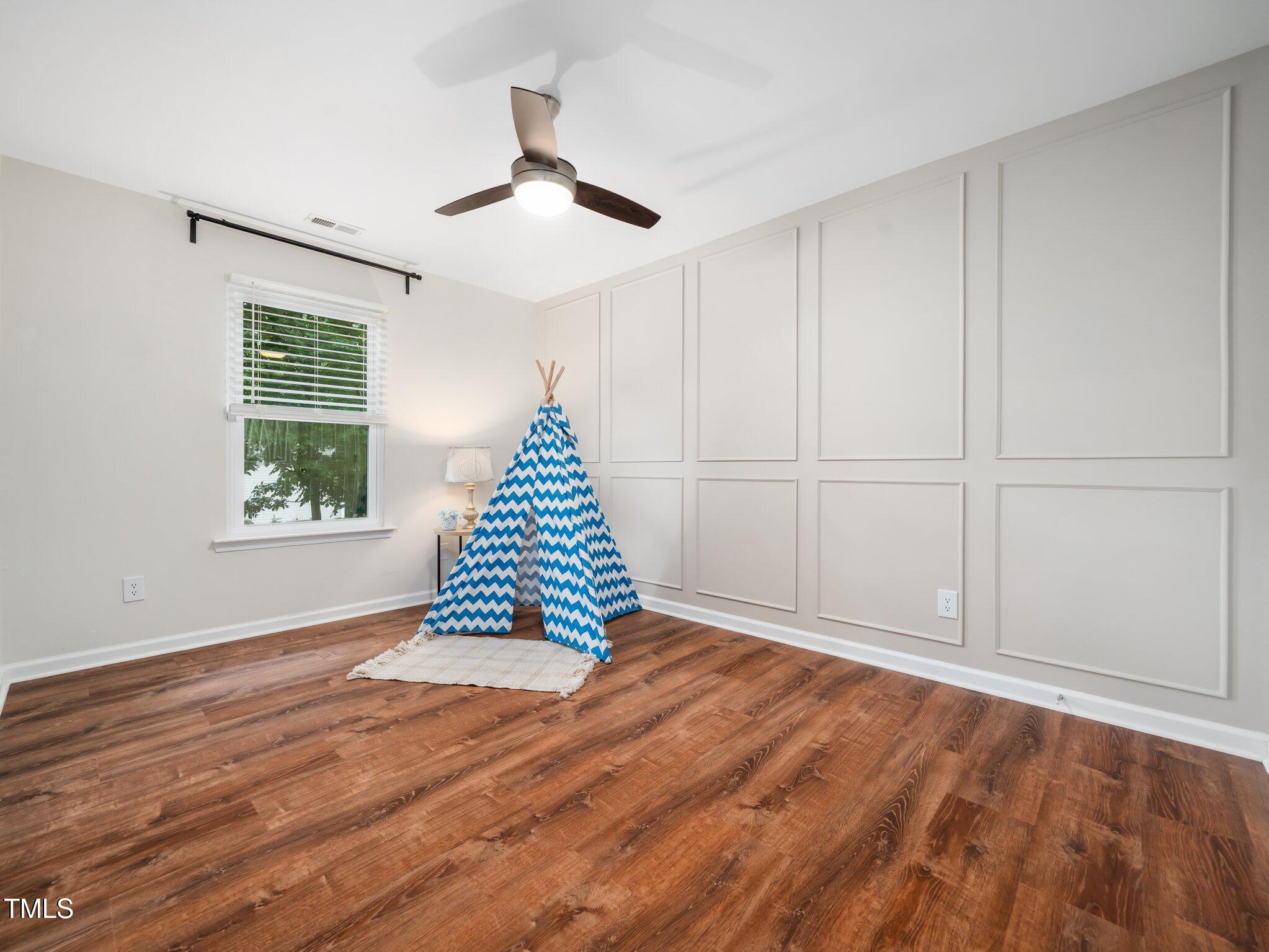 3400 Appling Way Durham, NC 27703 - Photo 19 of 30 a view of an empty room with wooden floor and a window