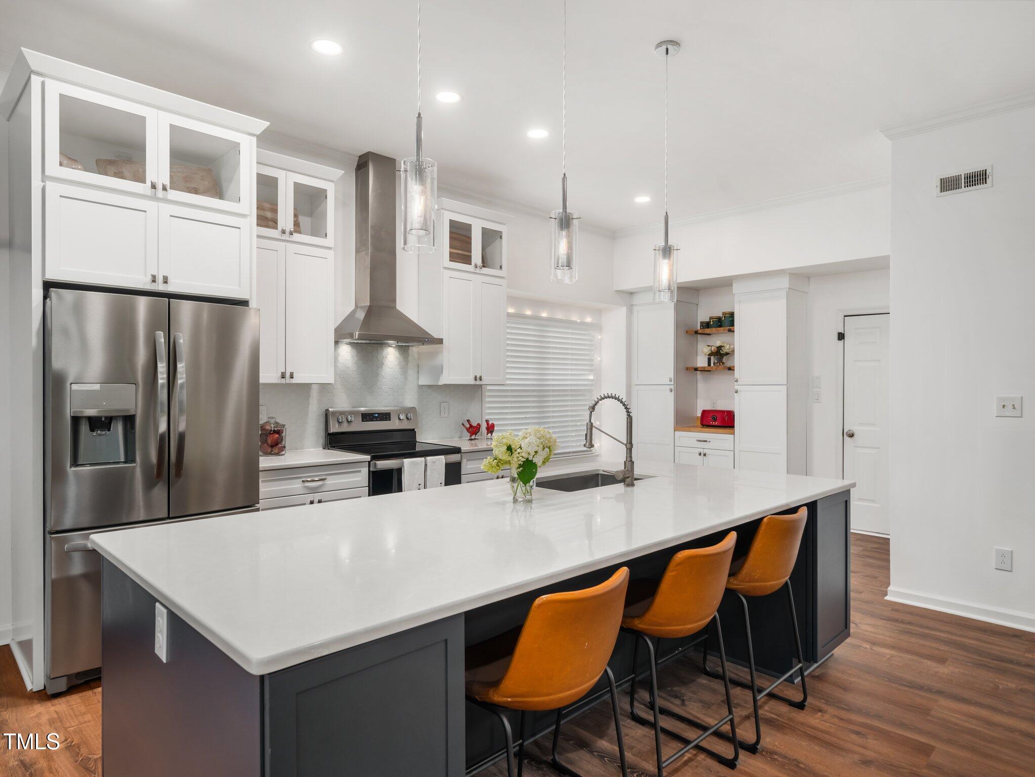 3400 Appling Way Durham, NC 27703 - Photo 8 of 30 a kitchen with stainless steel appliances a sink and refrigerator