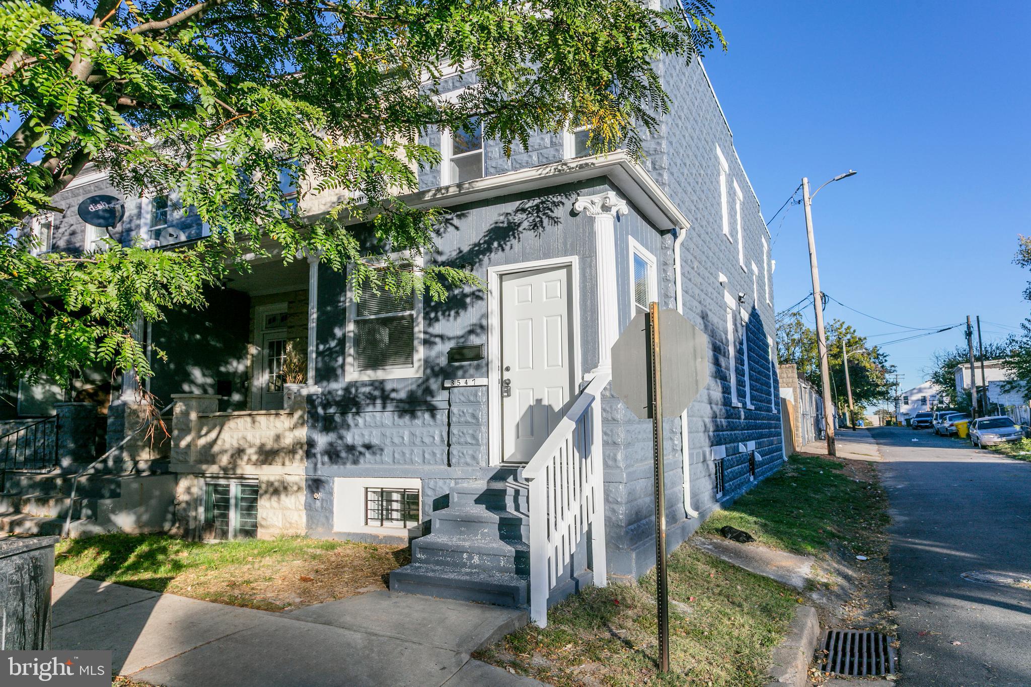 a view of a house with a tree in front of it