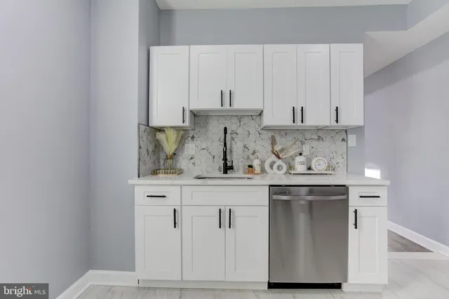a view of cabinets a wooden floor and a window