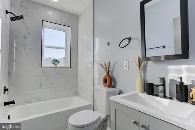 a bathroom with a sink a toilet and a bathtub