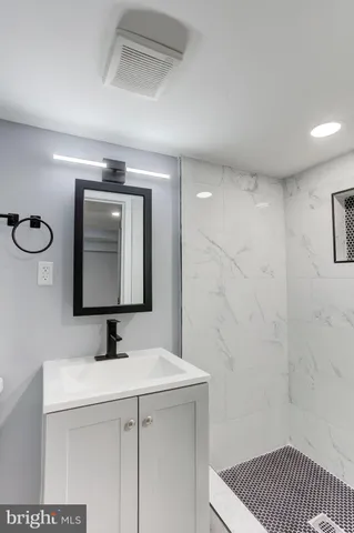 a bathroom with a sink a mirror and vanity