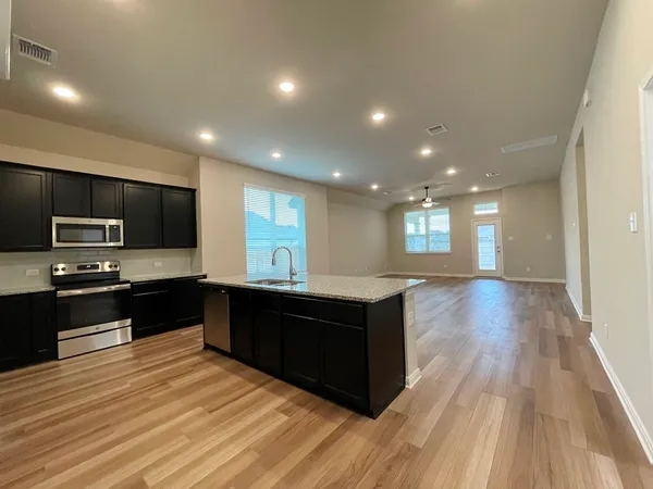 a view of a room with wooden floor and window