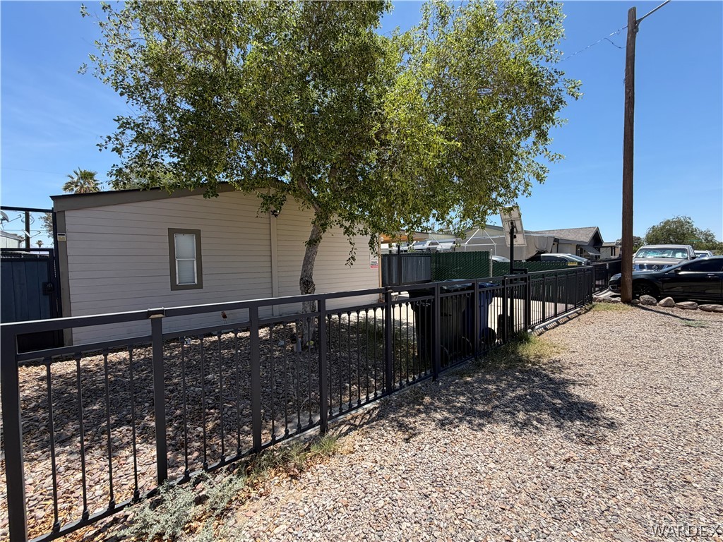 1910 Rio Grande Road Bullhead City, AZ 86442 - Photo 5 of 29 Exterior with horizontal siding, a single sash window, and a dark trim