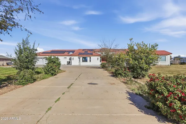 a pathway of a house with a yard