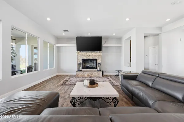 a living room with furniture a flat screen tv and a fireplace