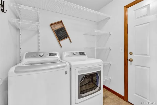 a bathroom with a sink a toilet and a large mirror
