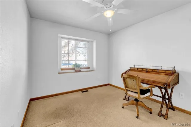 a view of a workspace with furniture and a chandelier fan